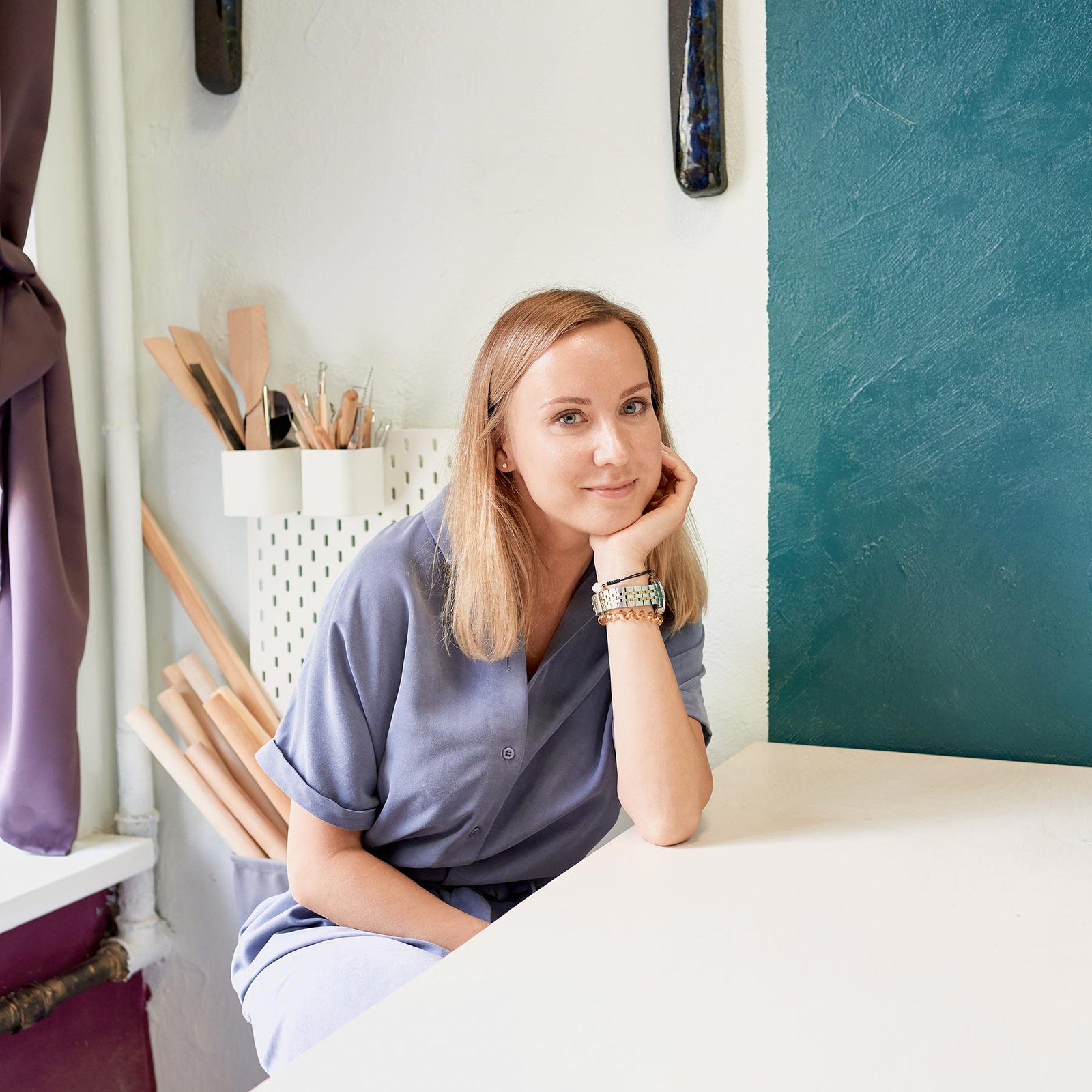 business-woman-sitting-at-table-and-smiling-in-cer-ZVJK2JG.jpg